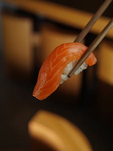 Close-up of a Sushi Piece Held with Chopsticks